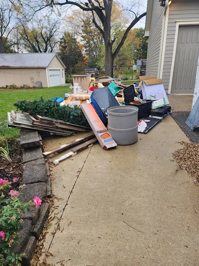 Dumpster being loaded with debris for Commercial Dumpster Rental in Bloomington